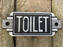Cast iron sign 'Toilet' in front of door