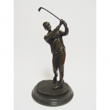 A bronze statue/sculpture of a golfer