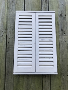  A mirror with hinged doors, made of wood