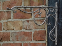 Ornate curved hanging basket wall hook - aged metal