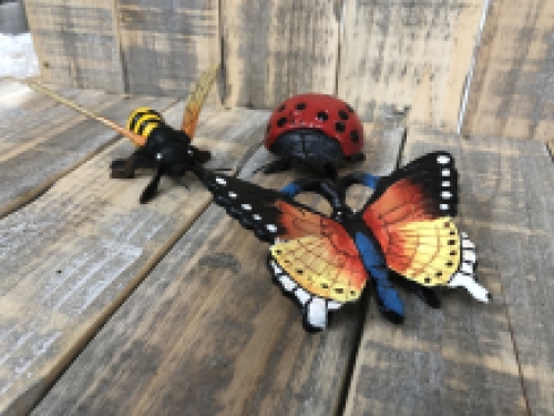 Cast iron figurines of a bee, butterfly and ladybird, full of colour.