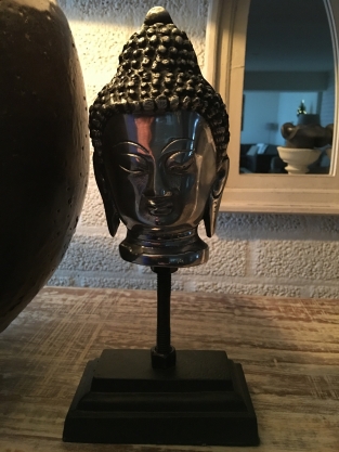 Buddha head on metal tripod, aluminum.