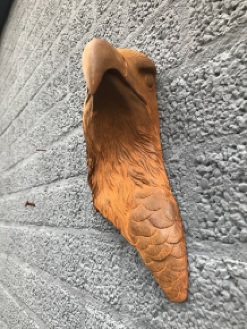 Eagle's head, cast iron wall ornament with rustic surface