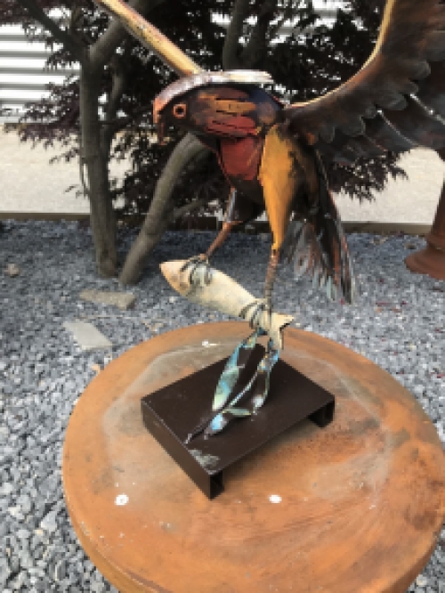 A metal artwork of an eagle catching a fish, ''IRON EAGLE''