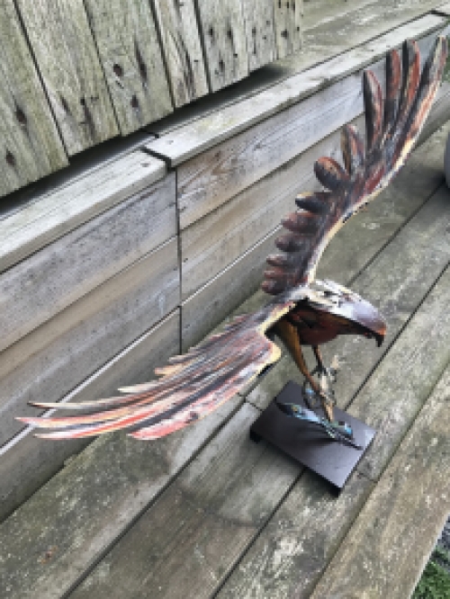 A metal artwork of an eagle catching a fish, ''IRON EAGLE''