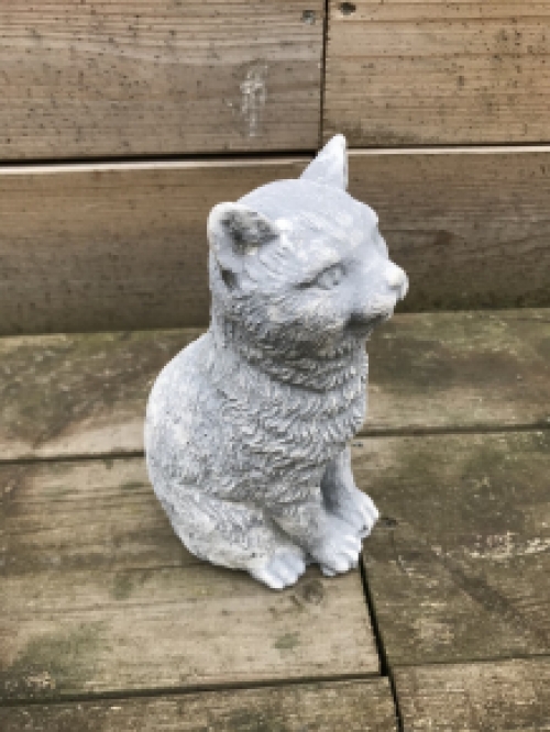 A beautiful sitting cat, made of stone, beautiful in detail